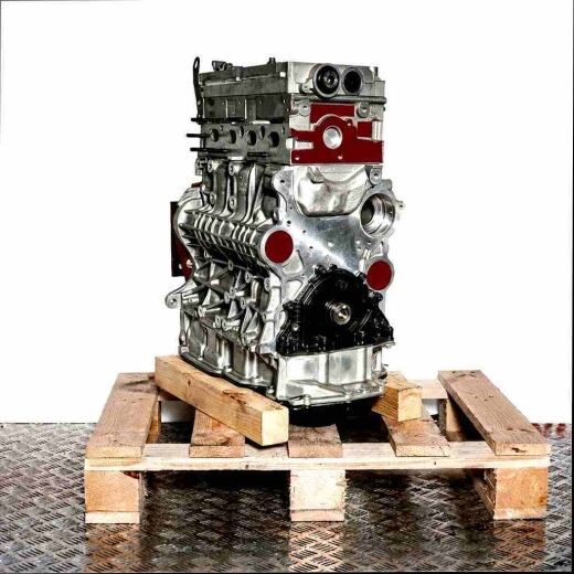 Side view of the DTUA engine on a wooden pallet against a white background. The metal engine displays detailed connections and components.