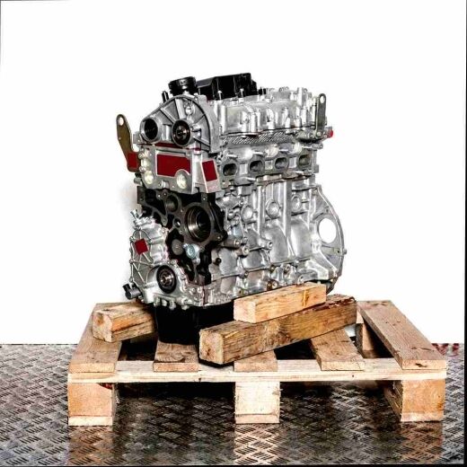Side view of engine F1AGL4112 on a wooden pallet against a white background. The silver and black engine comprises numerous mechanical components.