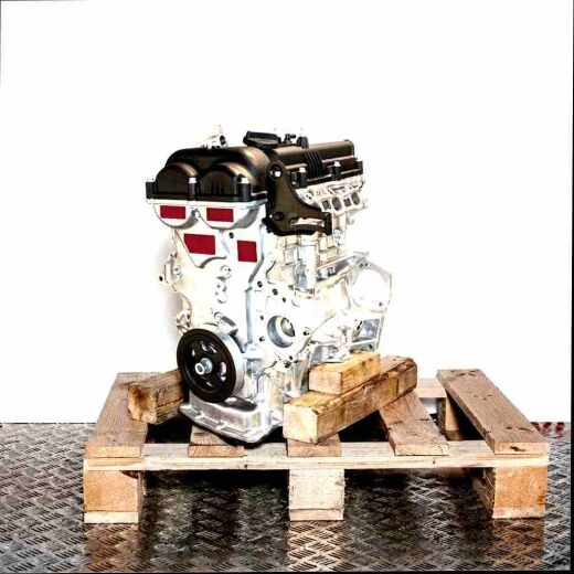 G4FD engine on a wooden pallet against a white background. Side view of the internal combustion engine, vertically oriented.