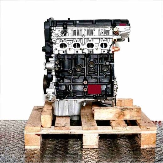 Black G4GC engine on a wooden pallet against a white background. The engine, featuring silver parts, is viewed from the side.