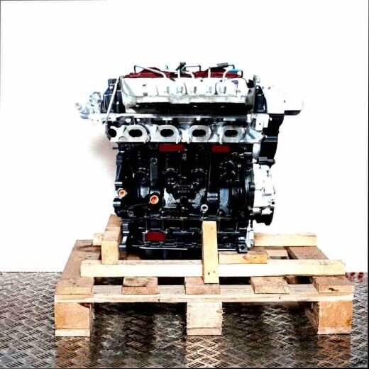 G9U 720 car engine in black and silver on a wooden pallet against a white background. Vertical front view.