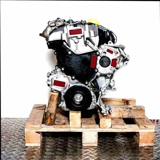 Side view of a G9U 724 engine on a wooden pallet against a white background. The silver-gray engine is vertically oriented.