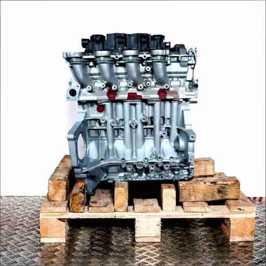 Side view of the HHDA engine on a wooden pallet against a white background. The light gray engine with black components is fully visible.
