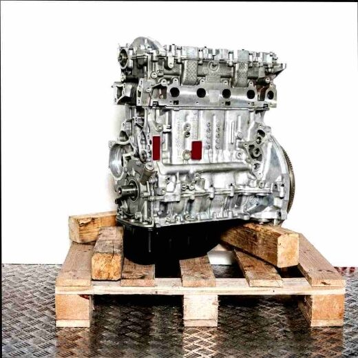 HHJE engine block on a wooden pallet against a white background. The bare engine, without attachments, is viewed from a slightly angled side perspective.