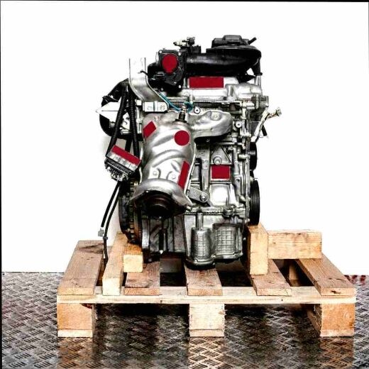 HR12DR engine on a wooden pallet against a white background. The engine is photographed from the side, showcasing all its components.