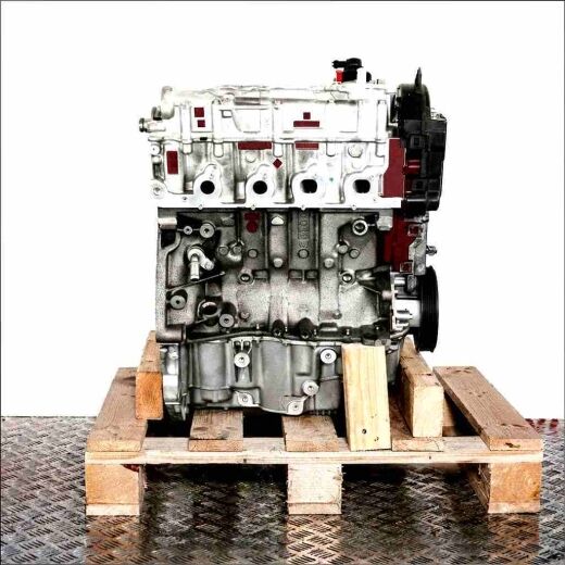 K9K 874 engine on a wooden pallet against a white background. Side view of the silver and black engine.