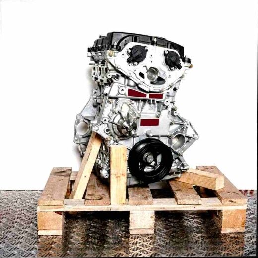 Side view of engine M 271.861 on a wooden pallet against a white background. The image focuses on the front of the engine, highlighting a large pulley.