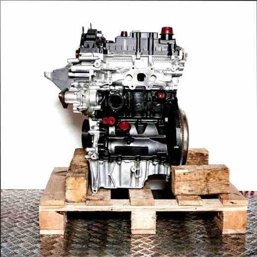 M1DC engine on a wooden pallet against a white background. The black engine block and metallic components are clearly visible. Yellow caps add detail.