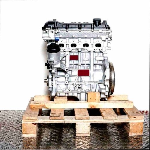 Side view of an M52 B25 (256S3) engine on a wooden pallet against a white background. The silver engine with black covers is slightly angled.