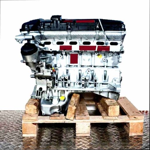 M52 B28 (286S1) engine on a wooden pallet against a white background. Side view of the silver engine.