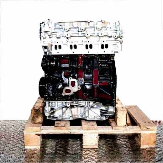 M9R 784 engine on a wooden pallet against a white background. The black and silver engine is viewed from the side.