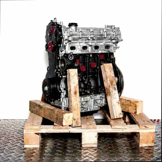 M9T 690 engine on a wooden pallet against a white background. The silver top contrasts with the darker lower parts.