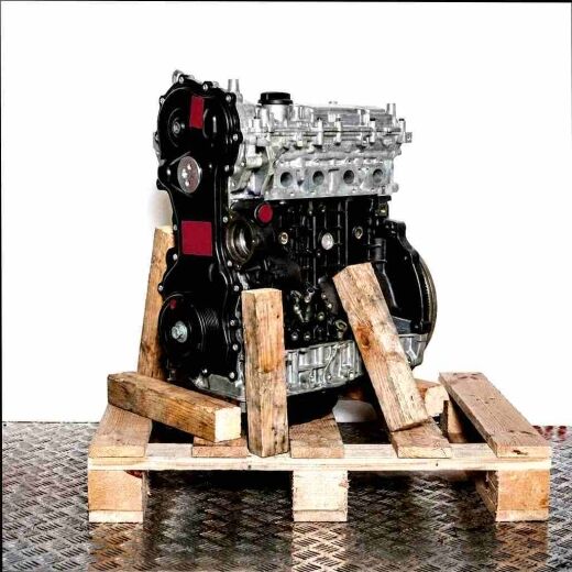 M9T 696 engine on a wooden pallet against a white background. Side view of the black and silver engine, slightly angled.