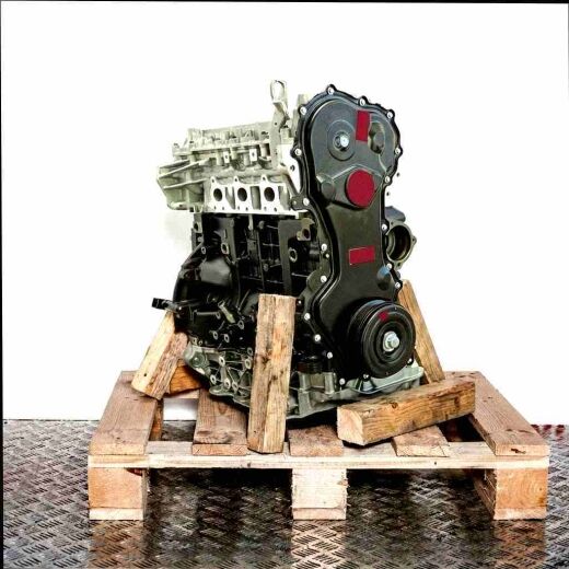 Engine M9T 702 in black and silver on a wooden pallet against a white background. Vertical shot from a slightly angled side view.