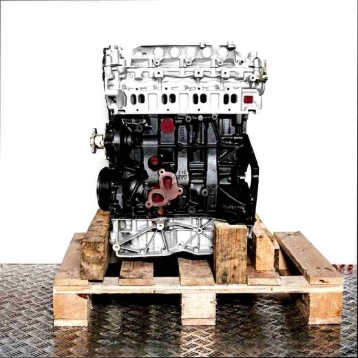 Engine M9T 708 in black and silver on a wooden pallet against a white background. The engine is viewed from the front/side.