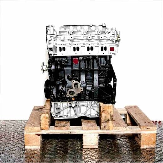 M9T 870 engine on a wooden pallet against a white background. The silver upper part and dark lower part of the engine are visible.