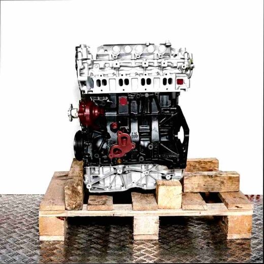 Side view of an M9T 896 engine on a wooden pallet against a white background. The engine features silver and black parts.