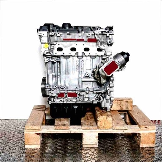 Side view of an N14 B16 AB engine on a wooden pallet against a white background. The silver and black engine with yellow accents is vertically oriented.