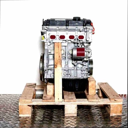 Side view of an N18 B16 A engine on a wooden pallet against a white background. The silver and black engine is vertically oriented.