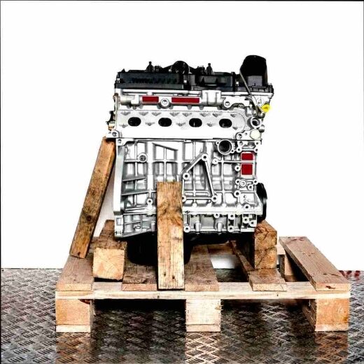 Side view of an N46 B20 CC engine on a wooden pallet against a white background. The silver and black engine with yellow caps is fully visible.