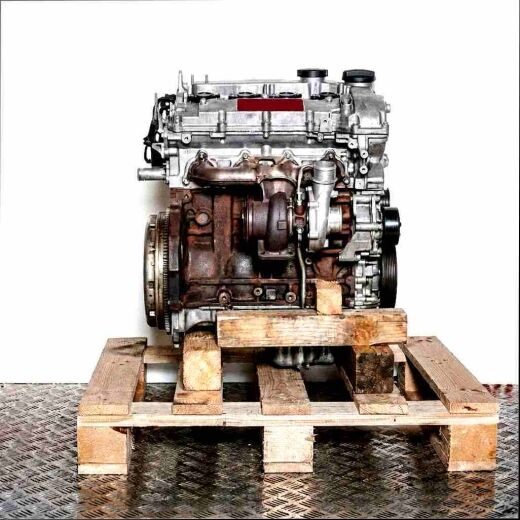 N54 B30 A engine on a wooden pallet against a white background. Angled top-down view of the engine.