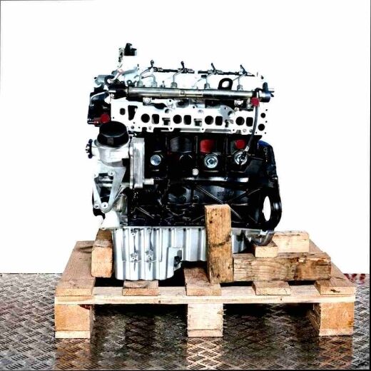 OM 646.989 diesel engine on a wooden pallet against a white background. Side view of the engine, perfect for parts or repairs.
