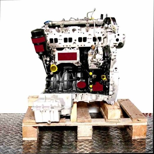 Side view of a silver and black OM 651.956 diesel engine on a wooden pallet. The engine is fully visible against a white background.