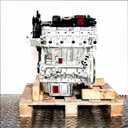 Side view of the T1WB engine on a wooden pallet against a white background. The grey engine with black covers displays details like screws and openings.