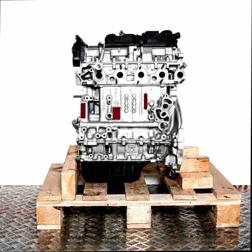T3JA engine block on a wooden pallet against a white background. Front view of the engine with black components, standing vertically.