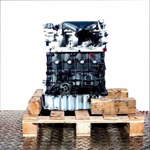 UFBB engine on a wooden pallet against a white background. The black engine block and silver cylinder head are visible, along with various attachments. Side view.