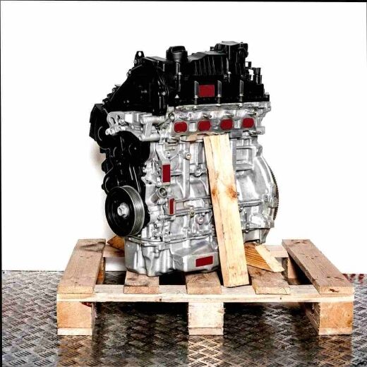 Side view of the UGCC engine on a wooden pallet against a white background. The engine is fully visible, with no logos present.