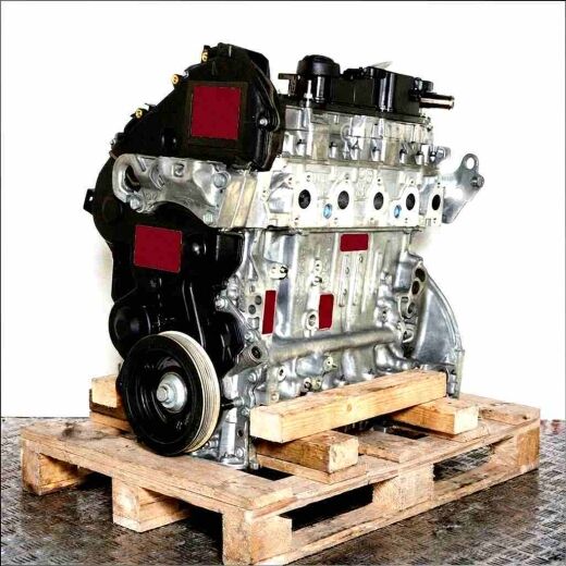 Side view of an UGJC engine on a wooden pallet against a white background. The engine is fully visible and upright.