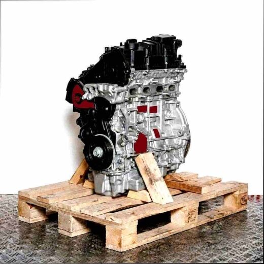 Side view of an XUGA engine on a wooden pallet. The silver and black engine is set against a white background.
