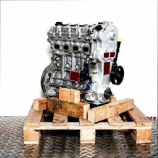 Side view of a Y 13 DT engine on a wooden pallet against a white background. The silver engine with black components is vertically oriented.