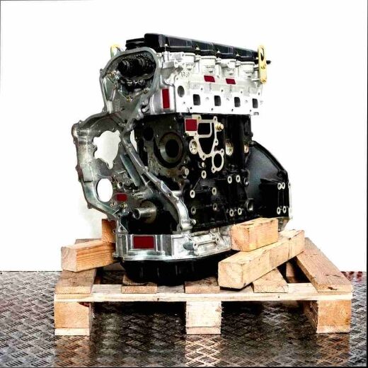 YD22ETI engine on a wooden pallet against a white background. The grey and black engine displays internal components. Side view.