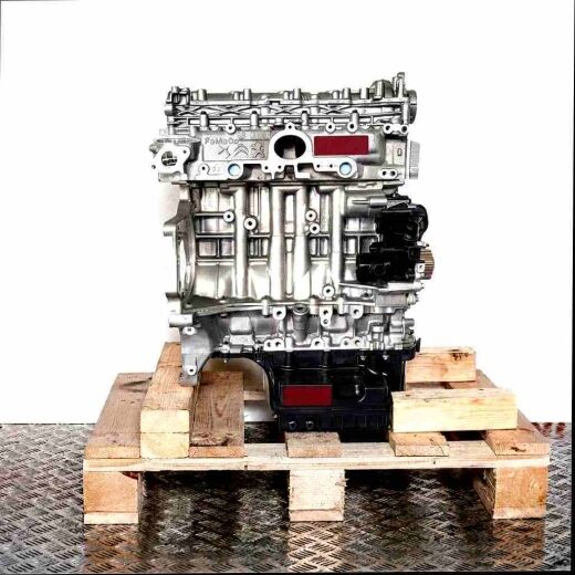 Silver ZTDB engine on a wooden pallet against a white background. The engine, featuring black components, displays various metal markings.